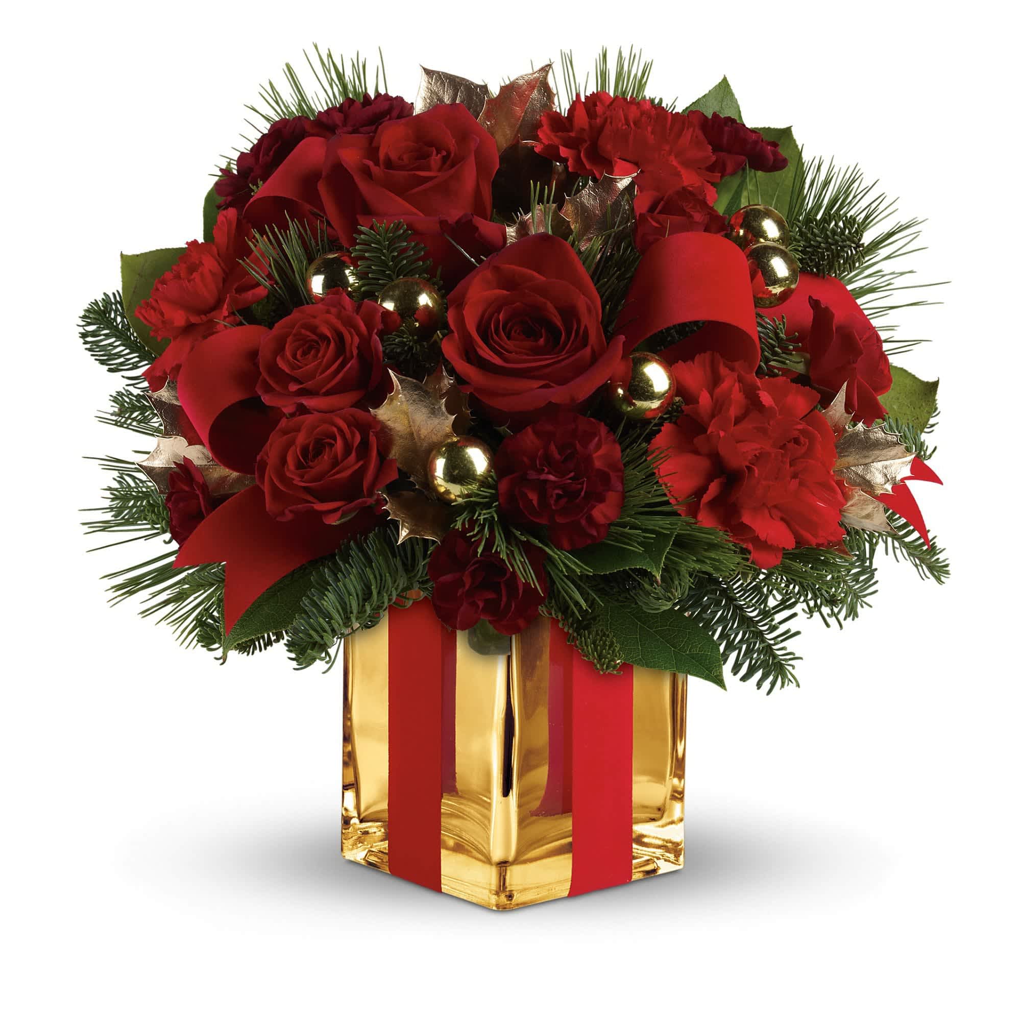 All Wrapped Up Bouquet by Teleflora - Lush red roses, fresh winter greens and a festive, gold mirrored glass cube are all wrapped up with red ribbon for an elegant, unforgettable gift!    This bouquet of deep red roses and spray roses, red carnations, maroon miniature carnations, green holly, noble fir, white pine and lemon leaf is dressed up with red velveteen ribbon and gold ornament balls. Delivered in a stunning gold Mirrored Cube vase.    Approximately 12 1/4" W x 11 3/4" H    Orientation: One-Sided    As Shown : TWR08-2A  Deluxe : TWR08-2B  Premium : TWR08-2C