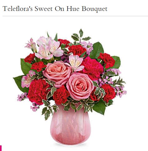 Pink and red mixed bouquet in a pink glass vase