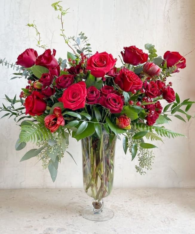 Red rose arrangement in a clear glass vase