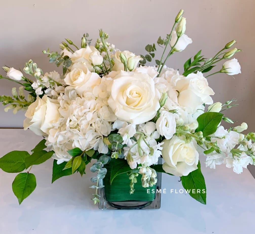 White rose and hydrangea arrangement in a glass vase