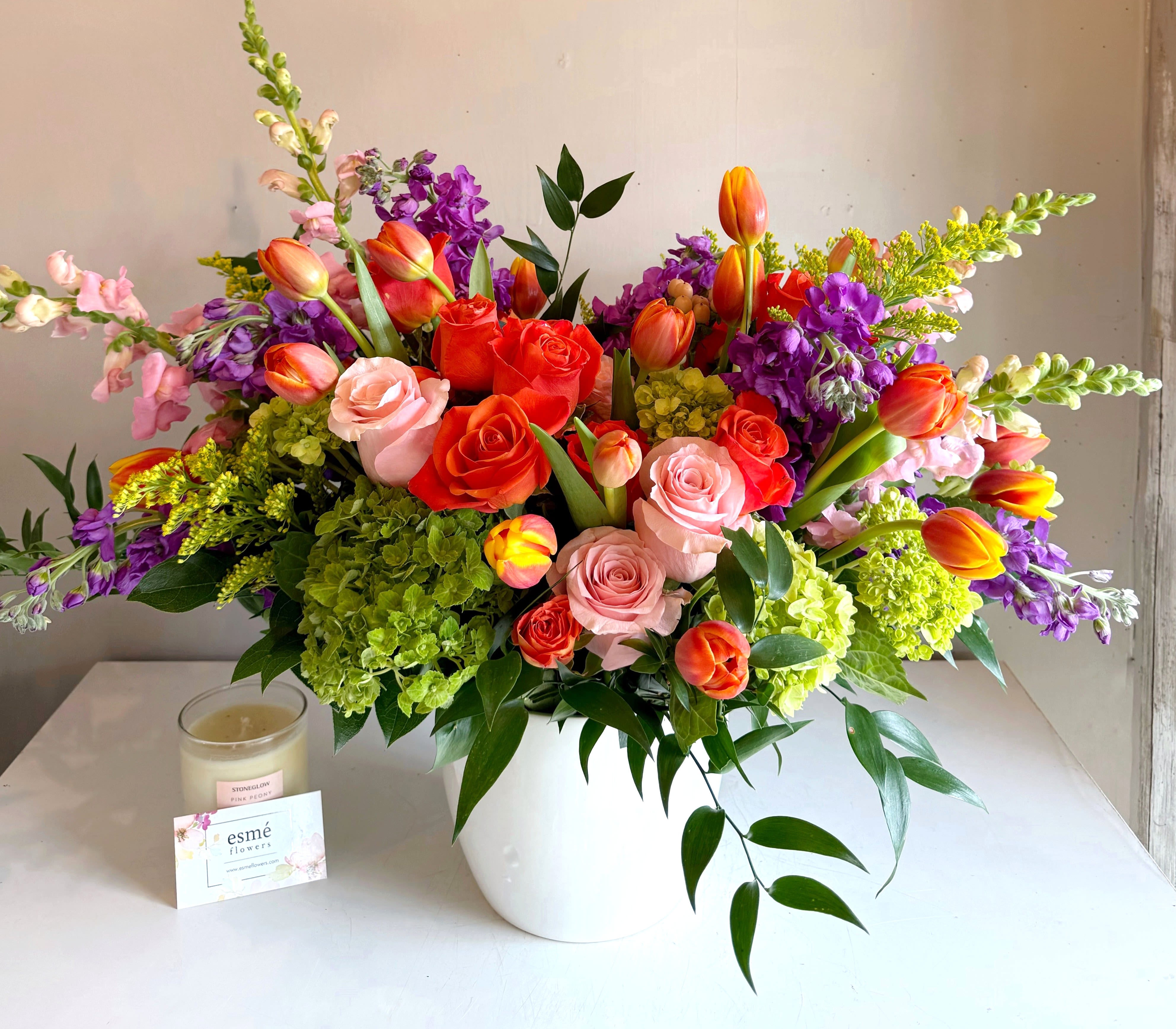 Sunkissed - A vibrant blend of orange, soft pinks, and purples,  designed to capture the feeling of a fresh spring breeze and golden summer light. Cheerful, radiant, and full of warmth, this arrangement brings an instant touch of happiness to any space.