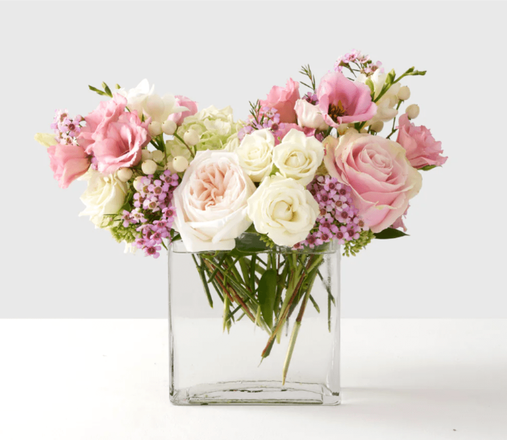 Pink and white roses in a clear glass vase