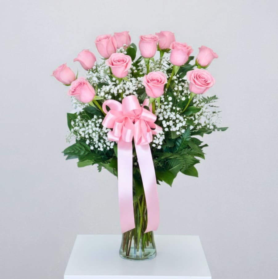 Long Stem Pink Roses - EVERYDAY COLLECTION | LOCAL DELIVERY ONLY  Say it sweeter with this feminine bouquet of 12 pink roses (Standard) designed with lush greens and touches of baby's breath in a glass gathering vase.  