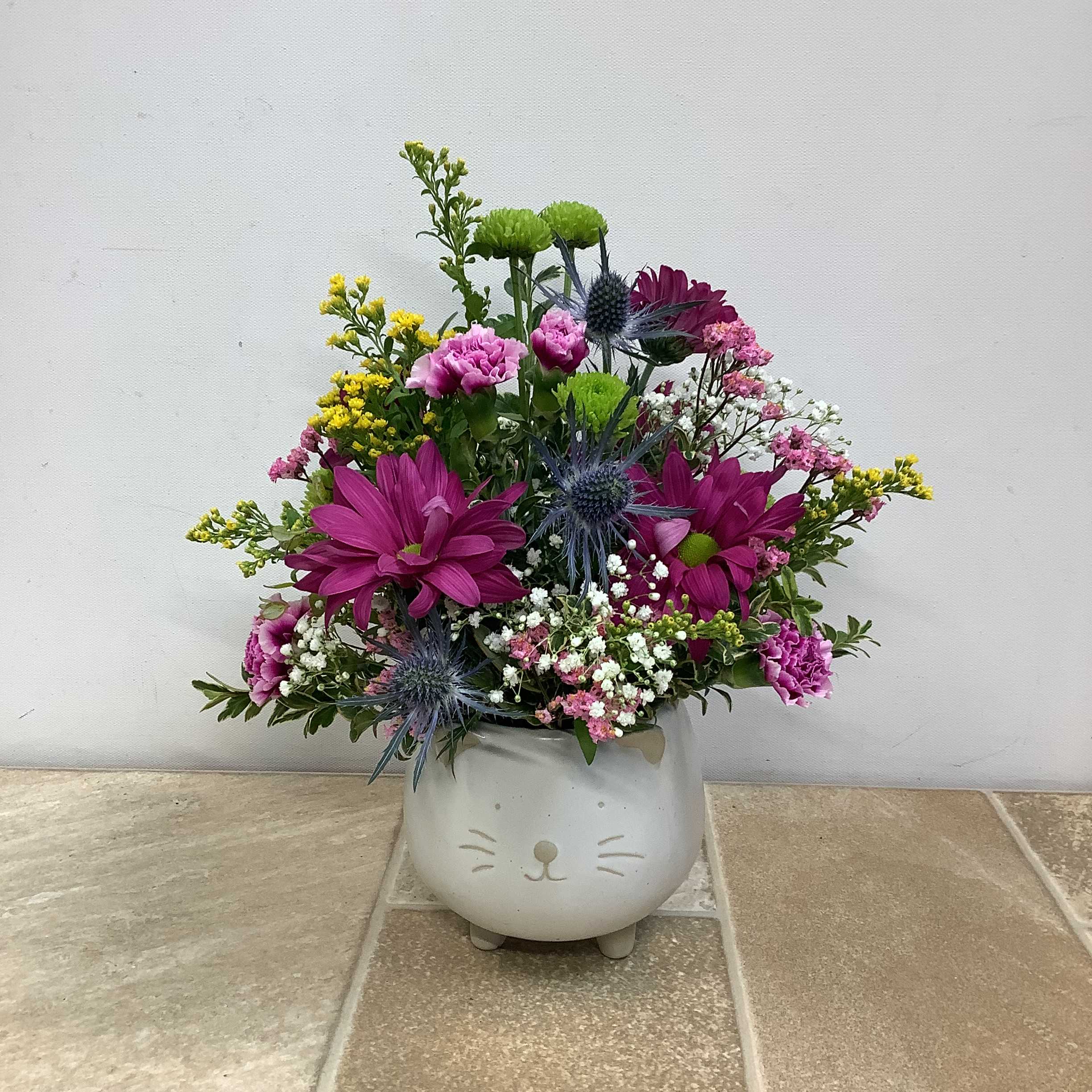 Purrfectly Charming - A perfectly charming bouquet of mixed blooms in a keepsake ceramic kitten vase. It measures 10” wide x 12” tall.