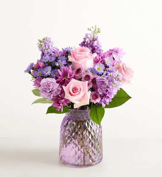 Daydream Bouquet - Just like a daydream. Our delightful lavender bouquet is gathered with accents of pink and lush greenery in our striking fluted violet gathering vase. Designed in vintage pressed glass with ribbed detailing, it captures the rich beauty of the blooms, along with the thoughtfulness of your sentiment.