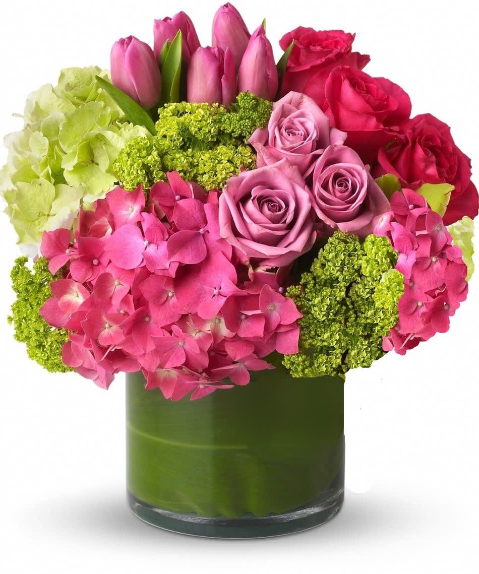 Pink and red roses with hydrangeas in a green glass vase