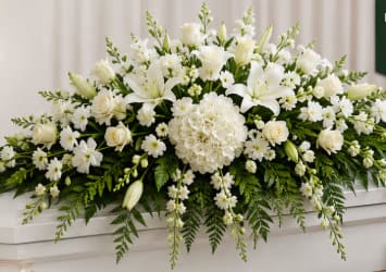 All White Casket Spray - Beautiful all white casket spray with roses, lilies, hydrangea, snap dragons, and a touch of greenery 