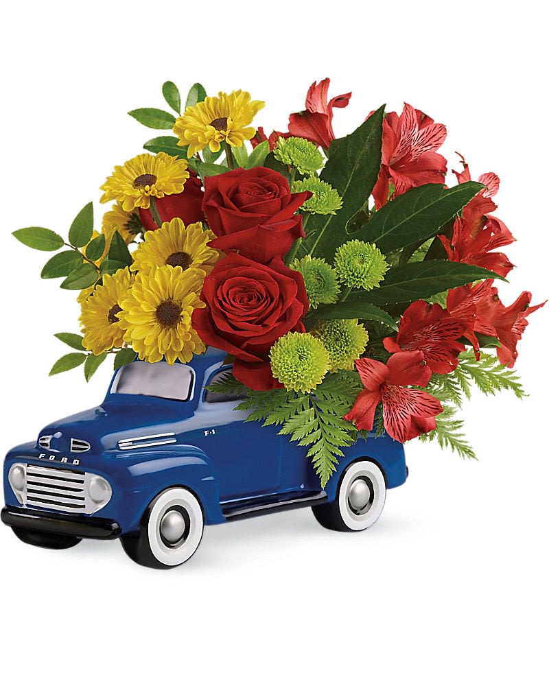 Blue toy truck holding a bouquet of red, yellow, and green flowers