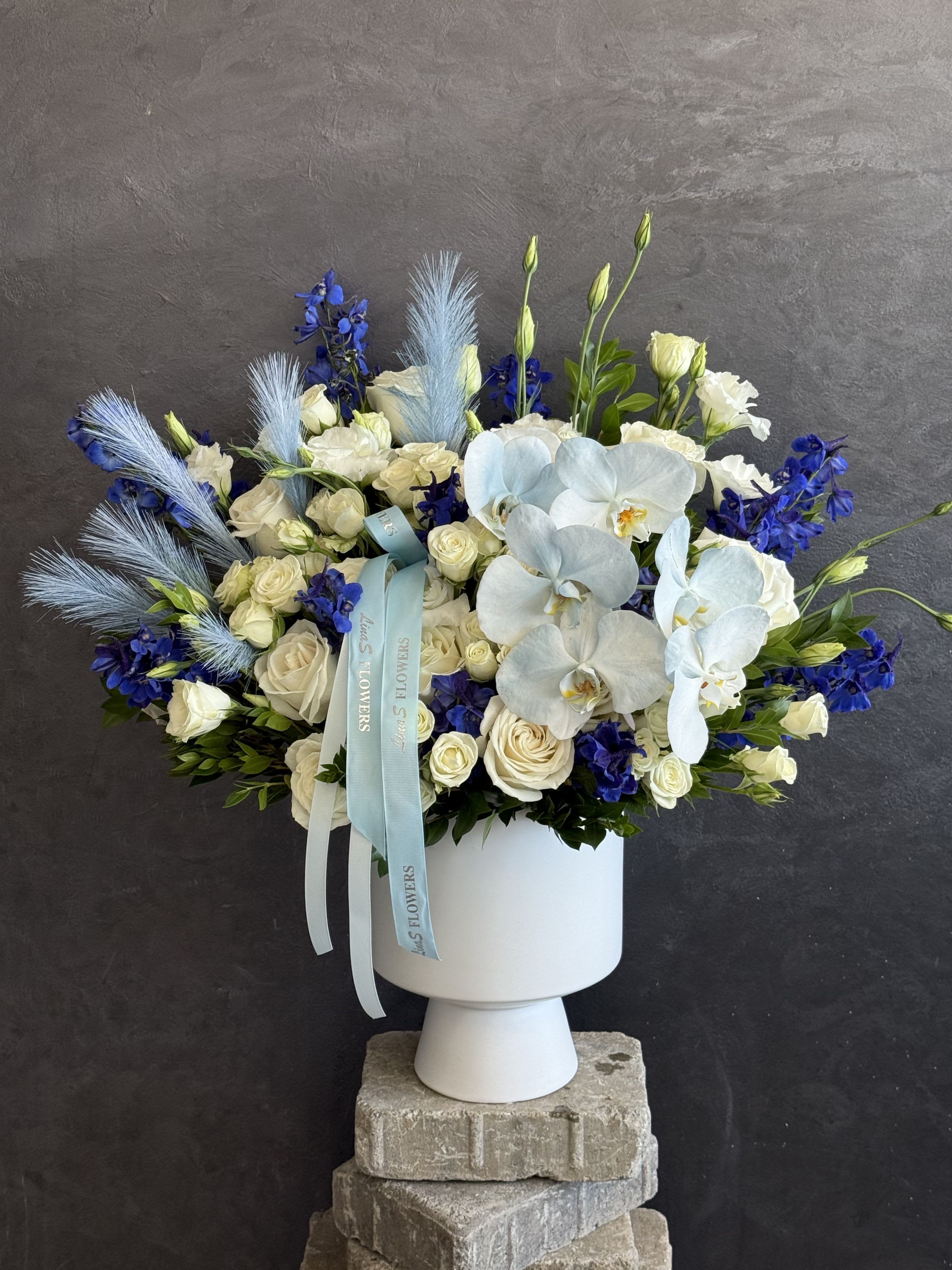 Amelia - A graceful blend of blue and white blooms, thoughtfully designed to bring freshness, elegance, and timeless beauty to any occasion. 
