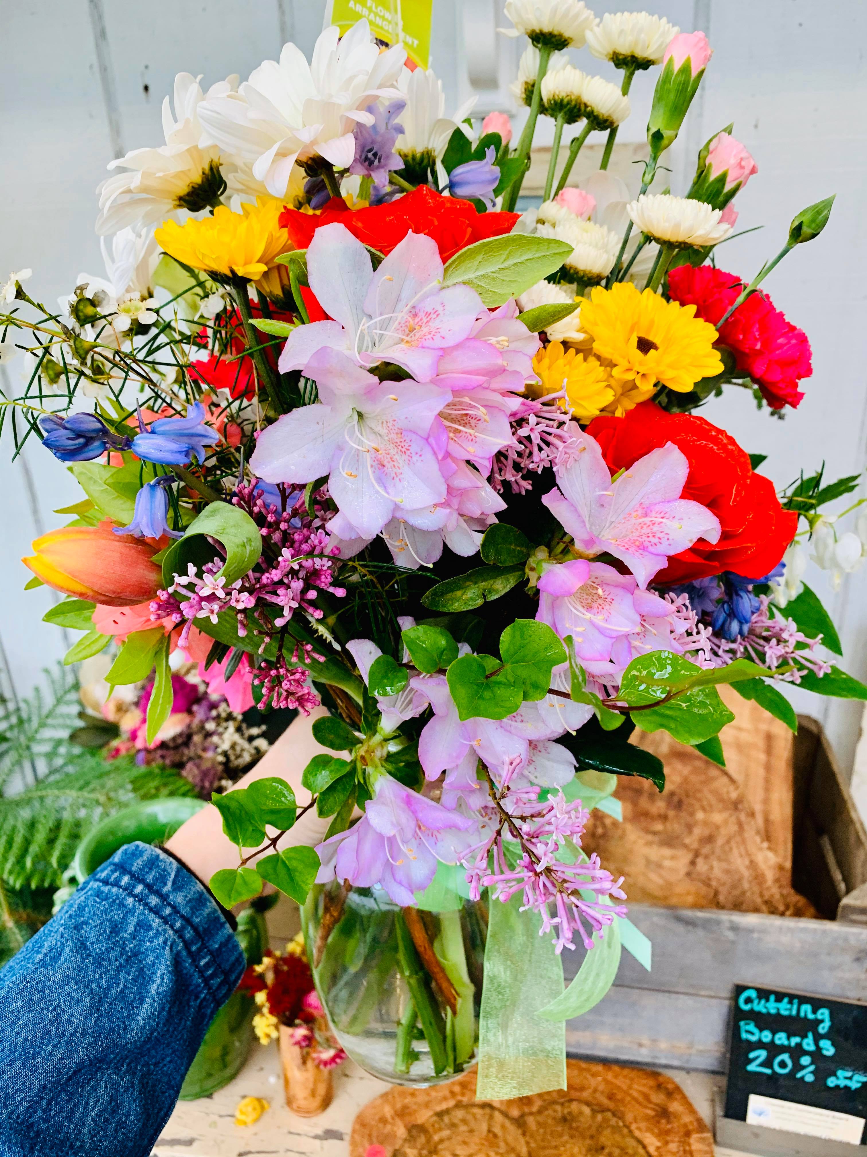 Mixed bouquet of colorful flowers in a glass vase