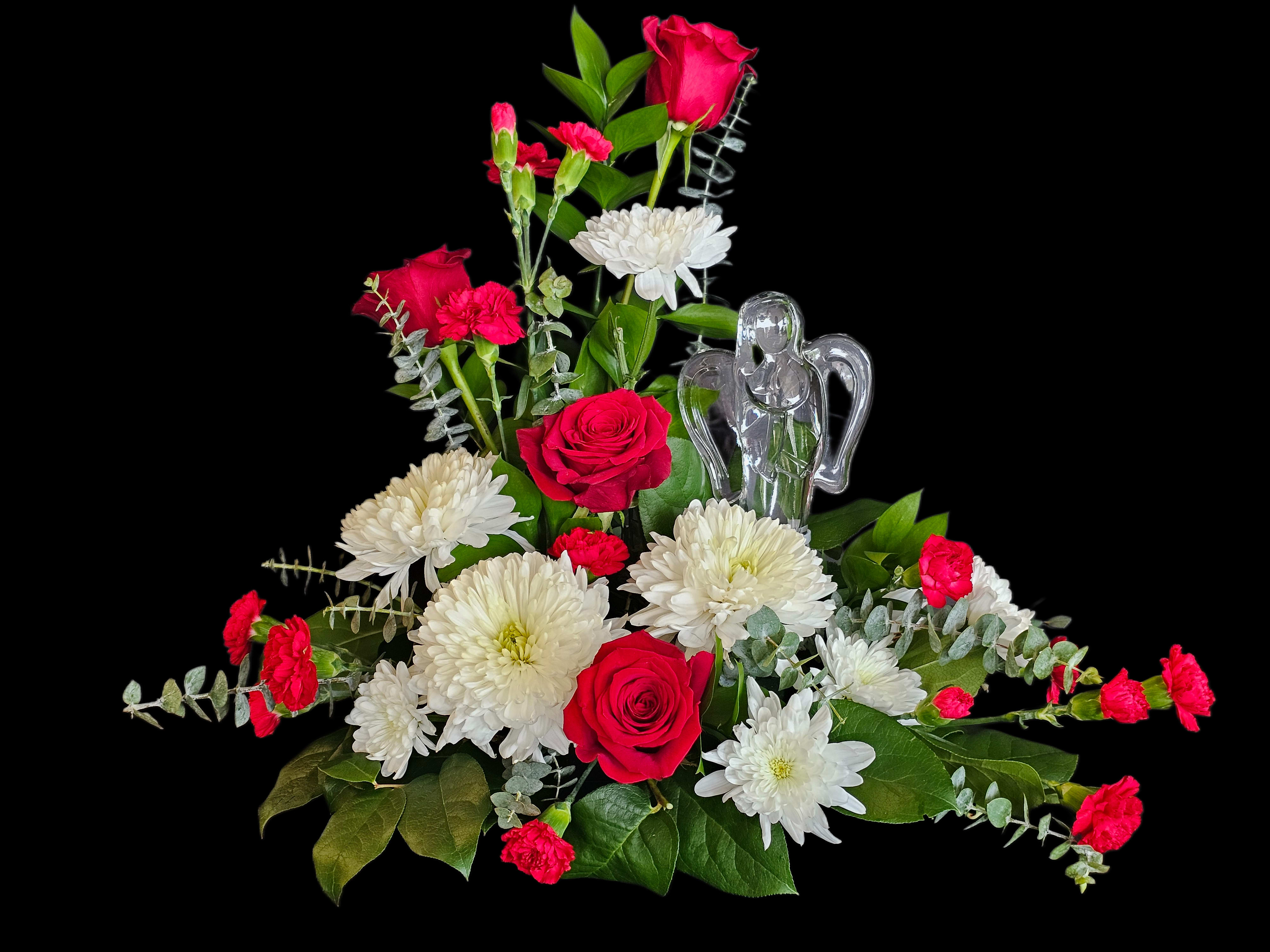 Devoted Love Crystal Angel   - This upright, layered arrangement showcases lush red roses at the core, surrounded by white mums and mini red carnations, with broad green foliage for structure and texture. The clear crystal angel keeps the focus on remembrance and care without feeling heavy; proportions are balanced for a medium display that fits on a table or mantle. It's the kind of floral gift that quietly communicates devotion and comfort, making someone feel genuinely supported and remembered.