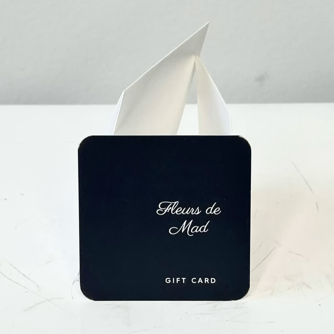 Black gift card with white folded insert