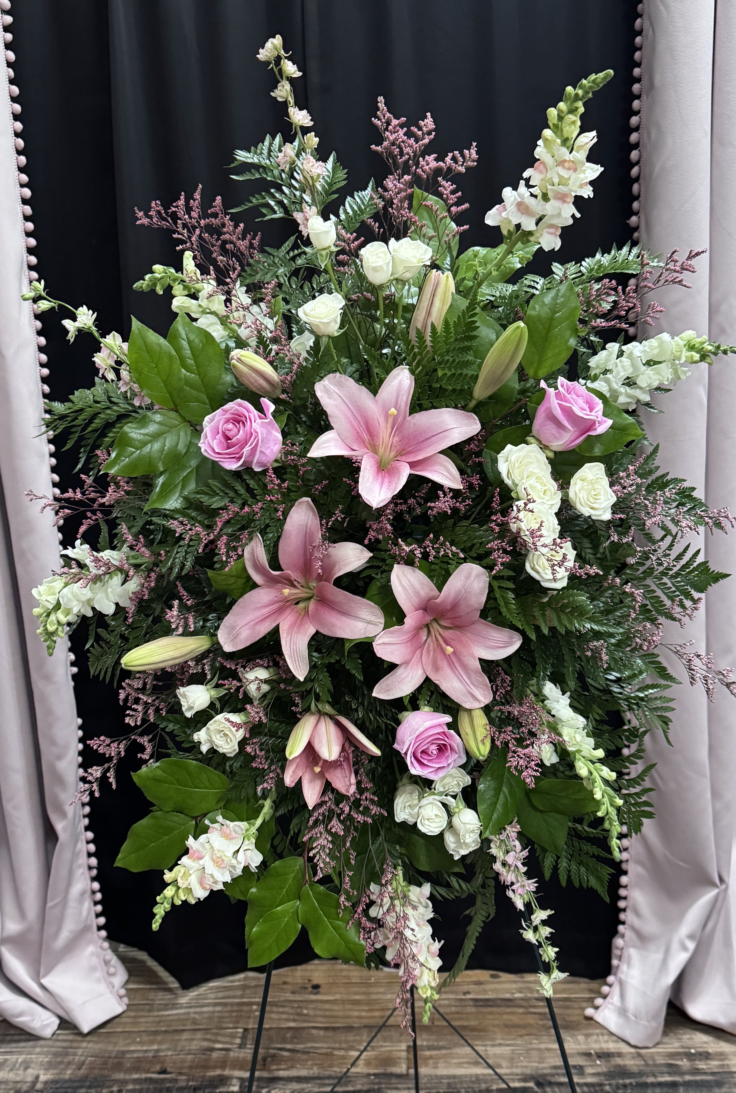Elegant Embrace Standing Spray - Our Elegant Embrace Standing Spray shares the warmth and comfort your loved ones need during this difficult time through each blushing bloom.