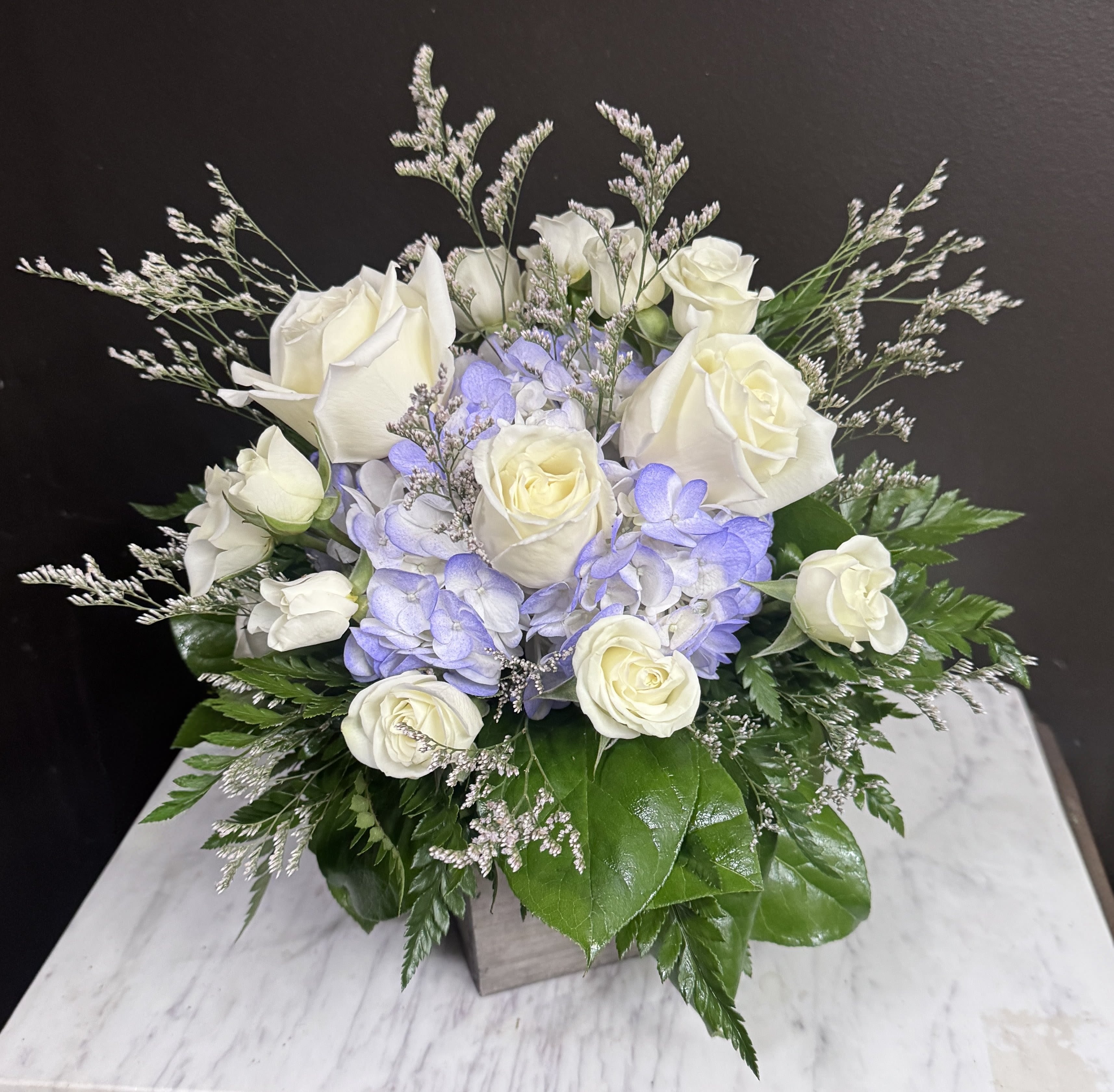 In the Clouds - Blue and white flowers in a wooden cube.