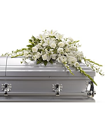 White floral casket spray on a silver casket