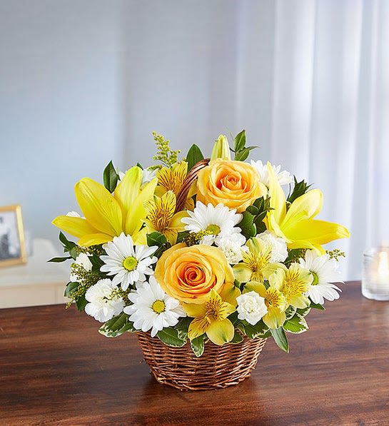 Yellow and white flower arrangement in a wicker basket