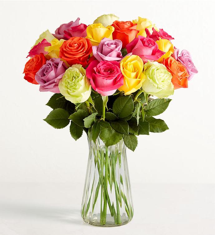 Colorful roses arranged in a clear glass vase