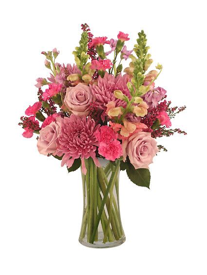 Eye Candy - Regency Vase, Pale Peach Snapdragons, Lavender Spider Or Cremon Mums , Pale Lavender Roses, Hot Pink Mini Carnations, Light Pink Stock, Fuchsia Heather. 
