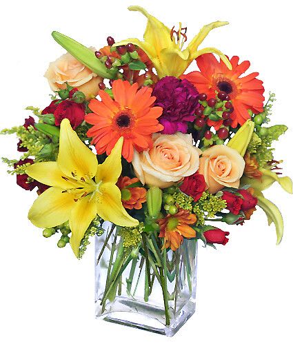 Floral Spectacular - Amazing occasions call for an amazing arrangement, and Floral Spectacular is definitely up to the challenge! This arrangement is filled to the brim with vibrant flowers, including yellow lilies, peach roses, orange gerbera daisies and more!  Includes Rectangular Vase, Yellow Asiatic Lilies, Orange Gerberas, Fuchsia Carnations, Pale Peach Roses, Red Spray Roses, Red Hypericum, Bronze Daisy Poms, Solidago (Separated).