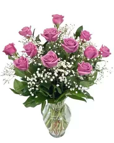 Pink roses in a glass vase with white baby's breath