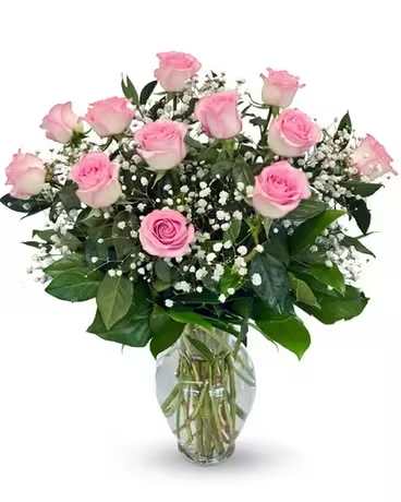 Pink roses and baby's breath in a clear glass vase
