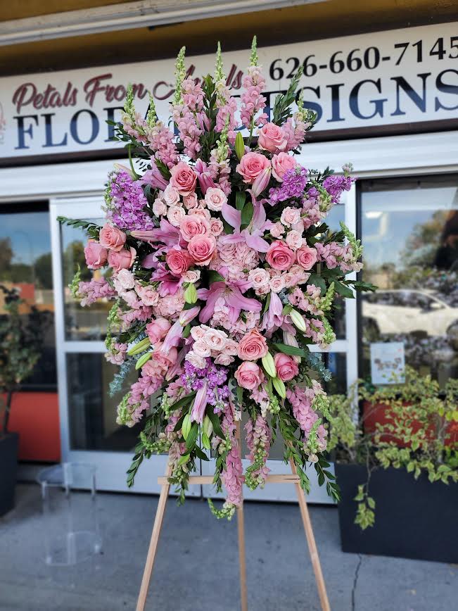 Large pink floral standing spray on an easel