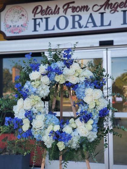 Large blue and white floral wreath on an easel