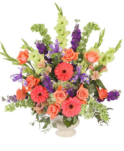 Bittersweet Evening - Send joyous blooms in celebration of the life of a dear friend with the Bittersweet Evening funeral arrangement that is perfect for any funeral, memorial service, or wake. Vibrant Gerberas and roses surrounded by luscious hydrangeas and purple irises bring out the bright spirit of someone you will never forget.  Includes Acrylic Urn Container, Foliage: Seeded Eucalyptus, Green Gladiolus, Bells Of Ireland, Coral Gerberas, Purple Larkspur, Orange Roses, Purple Iris, Orange Alstroemeria, Green Hydrangeas.