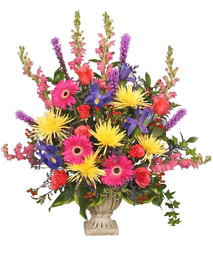 Colorful Condolences Tribute - Grecian Urn Container, Foliage: Hosta Leaves, Oregonia, Ivy, Ruscus, Leather Leaf, Hot Pink Gerberas, Blue Iris, Coral Roses, Pink Snapdragons, Purple Liatris, Misty Blue Limonium, Red Hypericum, Yellow Fuji Mums.