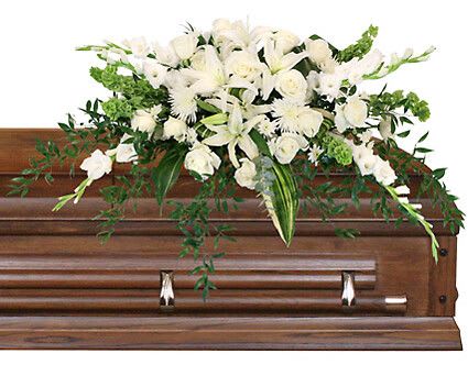 Hushed Goodbye - Send your loved one off with an elegant casket spray that truly encompasses the warmth they brought to your family with the Hushed Goodbye casket spray. White lilies, roses, and spider mums contrasting against a lush sea of aspidistra will bring comfort to the hearts of the family and friends in their time of grief and sorrow.  Includes Casket Saddle With Wet Floral Foam, Foliage: Aspidistra Leaves, Ruscus, White Gladiolus, White Lilies, White Roses, White Spider Mums, Bells Of Ireland, White Cushion Poms.