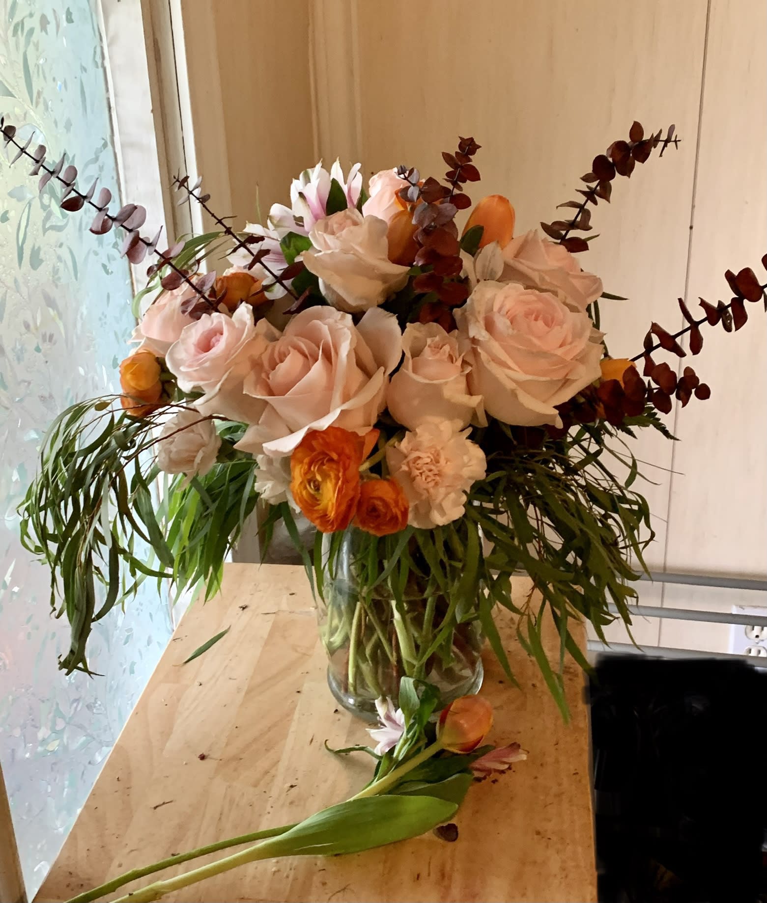 Pretty in Pink -  A Custom Design by Wonderland Flowers - Designed by Wonderland Flowers, we are pleased to bring you something different. Willow eucalyptus surrounds this boho inspired arrangement with half a dozen pink roses, sunset ranunculus, alstroemerias, finished off with red baby eucalyptus. feel free to upgrade your arrangement with our deluxe and premium options below. Deluxe will have one full dozen roses. Premium will contain 16 roses. 