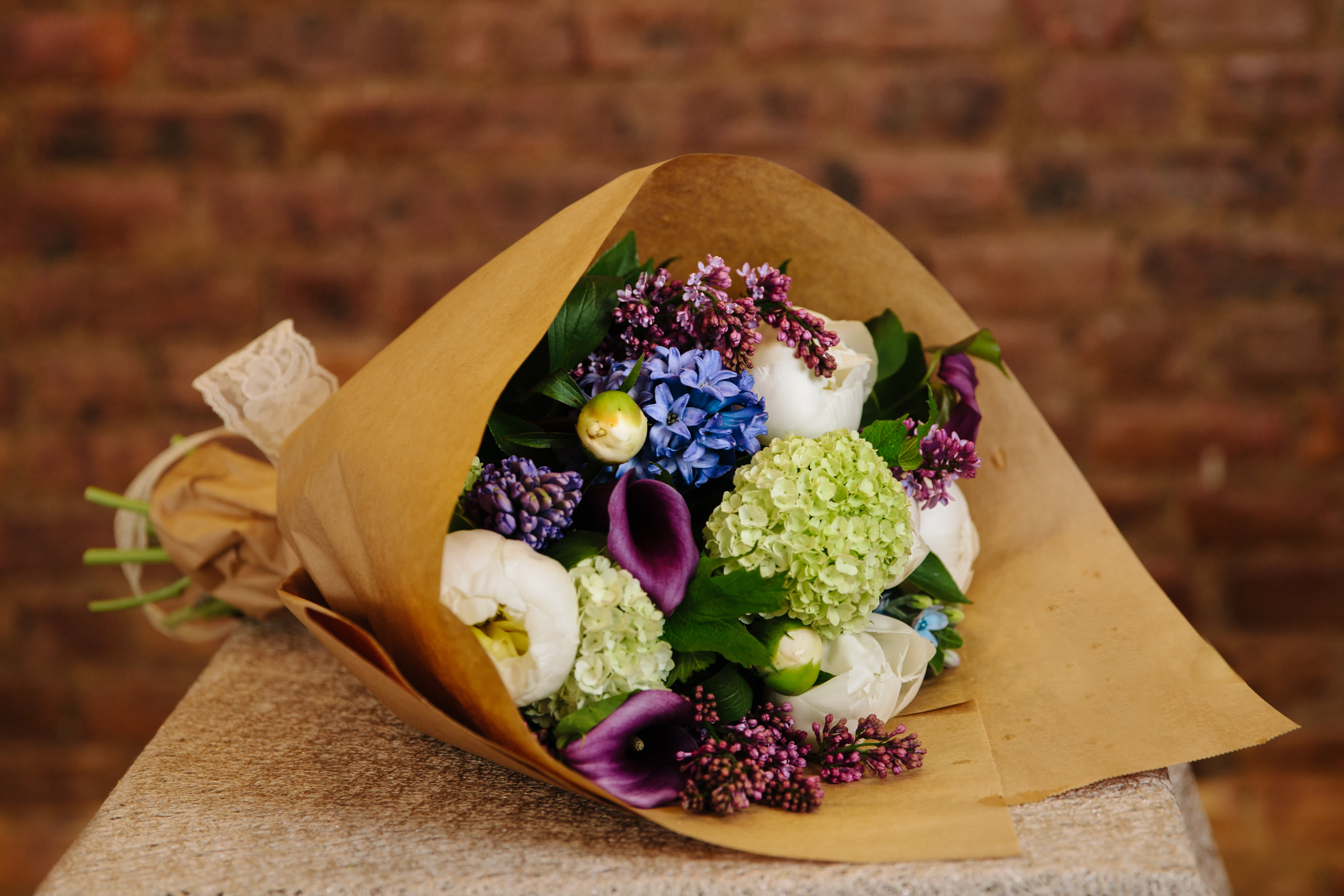 Bouquet of mixed flowers wrapped in brown paper