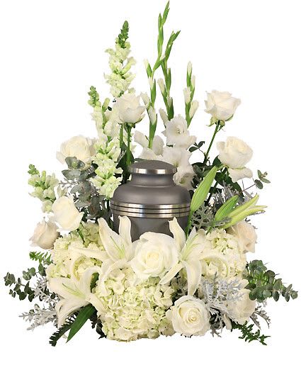 Eternal Peace Urn - Reminisce and cherish the life of a lost loved one with the Eternal Peace cremation arrangement that encompasses the urn of your choice. This classy arrangement features heavenly white hues with lavish hydrangeas, lilies, and roses, making it ideal for any memorial service. Urn Not Included  Includes Casket Saddle With Wet Floral Foam, Foliage: Silver Dollar Eucalyptus, Dusty Miller, Sword Fern, White Hydrangeas, White Gladiolus, White Roses, White Snapdragons, White Lilies.