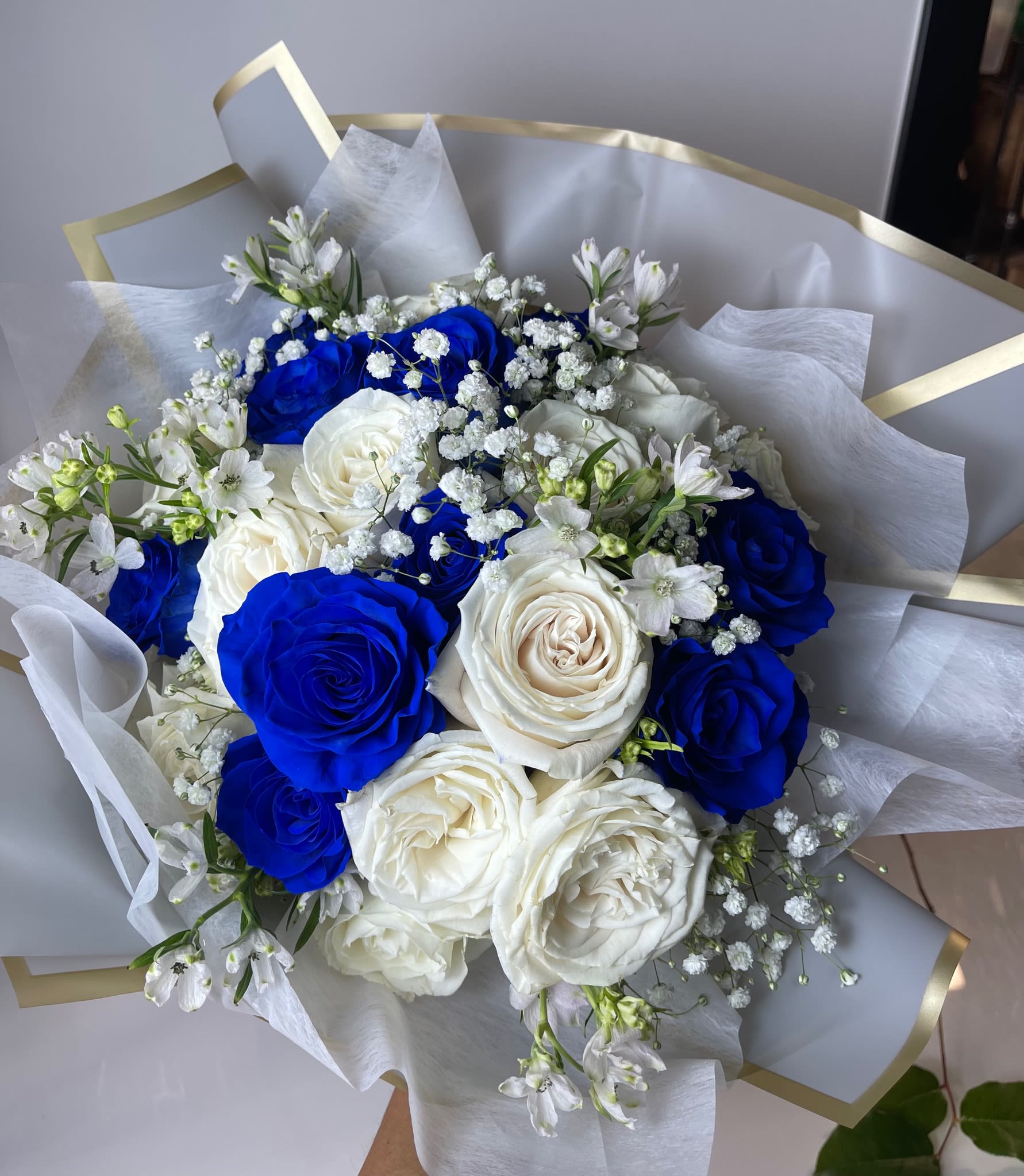 Bouquet of blue and white roses with small white filler flowers