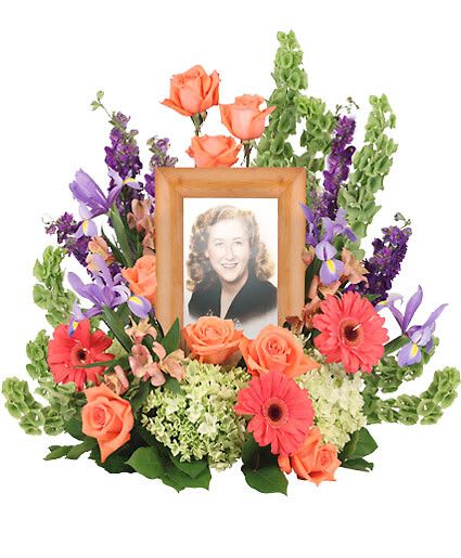 Bittersweet Twilight Memorial - Remember the spirit of a loved one with the Bittersweet Twilight Memorial arrangement, elegantly designed to encompass a photograph. Vibrant peach roses and coral Gerberas highlight the brightness of the spirit while the pale green hydrangeas comfort the heart in this time of sorrow. Picture Frame not Included  Includes Large Wet Floral Foam Cage, Foliage: Salal, Peach Roses, Bells Of Ireland, Purple Larkspur, Green Hydrangeas, Coral Gerberas, Light Purple Iris, Peach Alstroemeria.