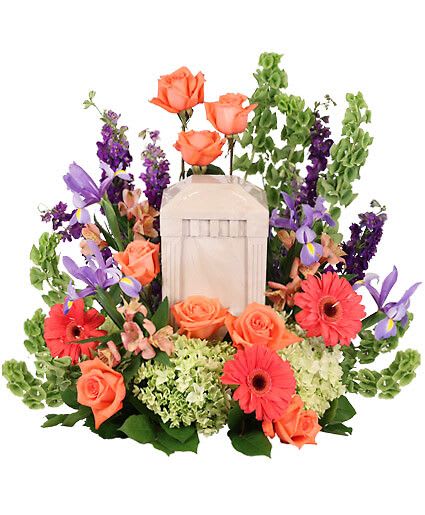 Bittersweet Twilight Memorial Urn - Remember the spirit of a loved one with the Bittersweet Twilight Memorial cremation arrangement, elegantly designed to encompass the urn you and your family have chosen. Vibrant peach roses and coral Gerberas highlight the brightness of the spirit while the pale green hydrangeas comfort the heart in this time of sorrow. Urn Not Included  Includes Extra Large Cage W Wet Floral Foam, Foliage: Salal, Peach Roses, Bells Of Ireland, Purple Larkspur, Green Hydrangeas, Coral Gerberas, Lavender Iris, Peach Alstroemeria.