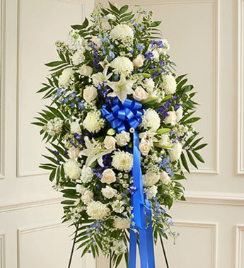 Deepest Sympathies Blue &amp; White Standing Spray - Product ID: 91287   Show all the love and compassion you have in your heart during times of loss with our beautiful blue and white standing spray. Gathered fresh with blue and white blooms, this expertly crafted arrangement is a tasteful and touching expression of your care and concern. Standing spray arrangement of fresh blue delphinium gathered with white roses, lilies, mums, stock, carnations and more Appropriate for family, friends or business associates to send directly to the funeral home Our florists use only the freshest flowers available, so colors and varieties may vary Large measures approximately 52"H x 42"L without easel Medium measures approximately 46"H x 38"L without easel Small measures approximately 42"H x 30"L without easel