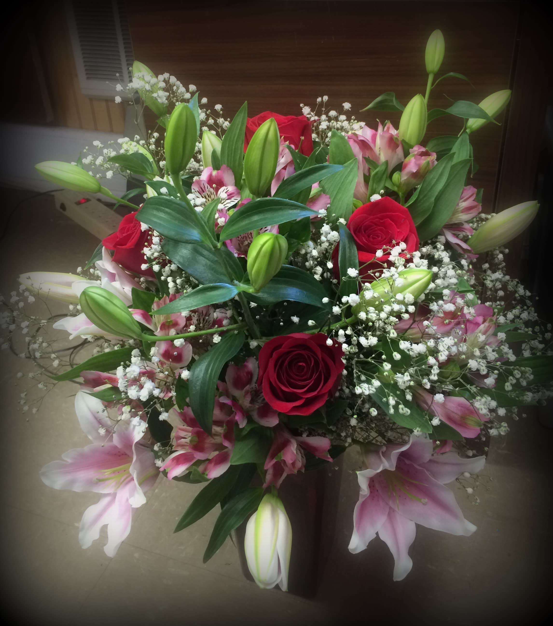 Bouquet of red roses, pink lilies, and white baby's breath