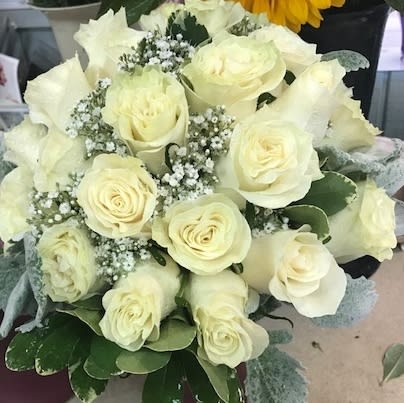 Bouquet of white roses with baby's breath and greenery