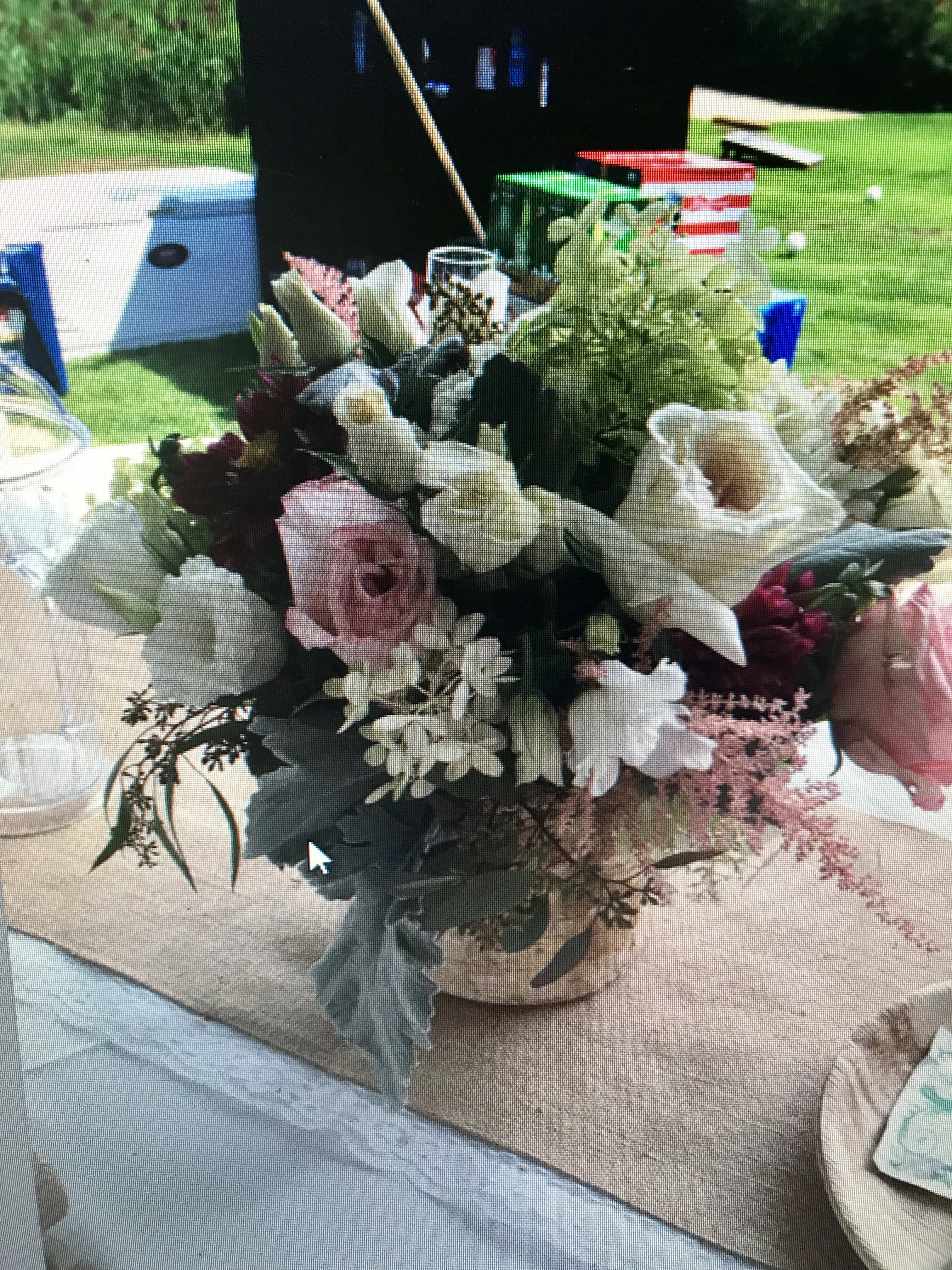 Mixed floral centerpiece with pink and white blooms in a low container