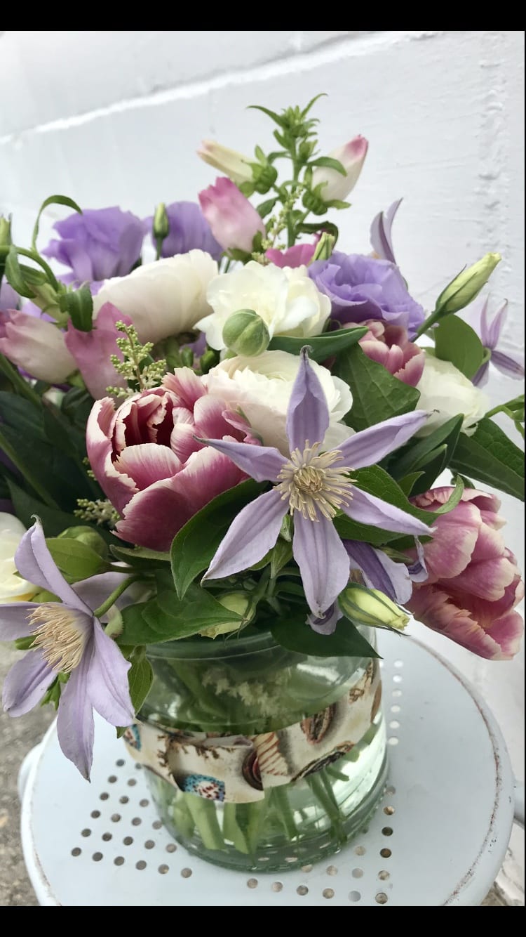 Bouquet of pink, white, and lavender flowers in a glass vase