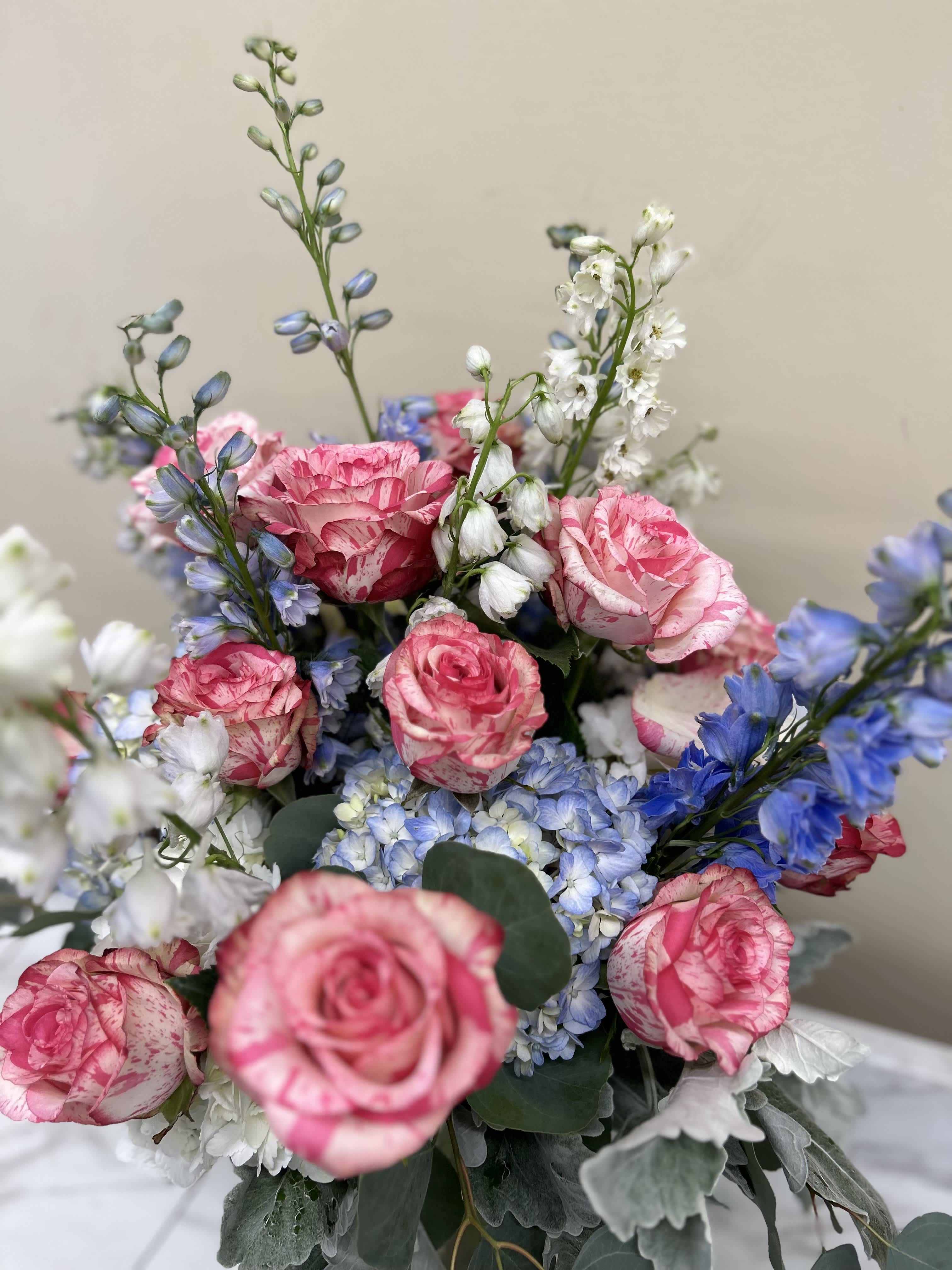 Bouquet of pink roses with blue and white flowers