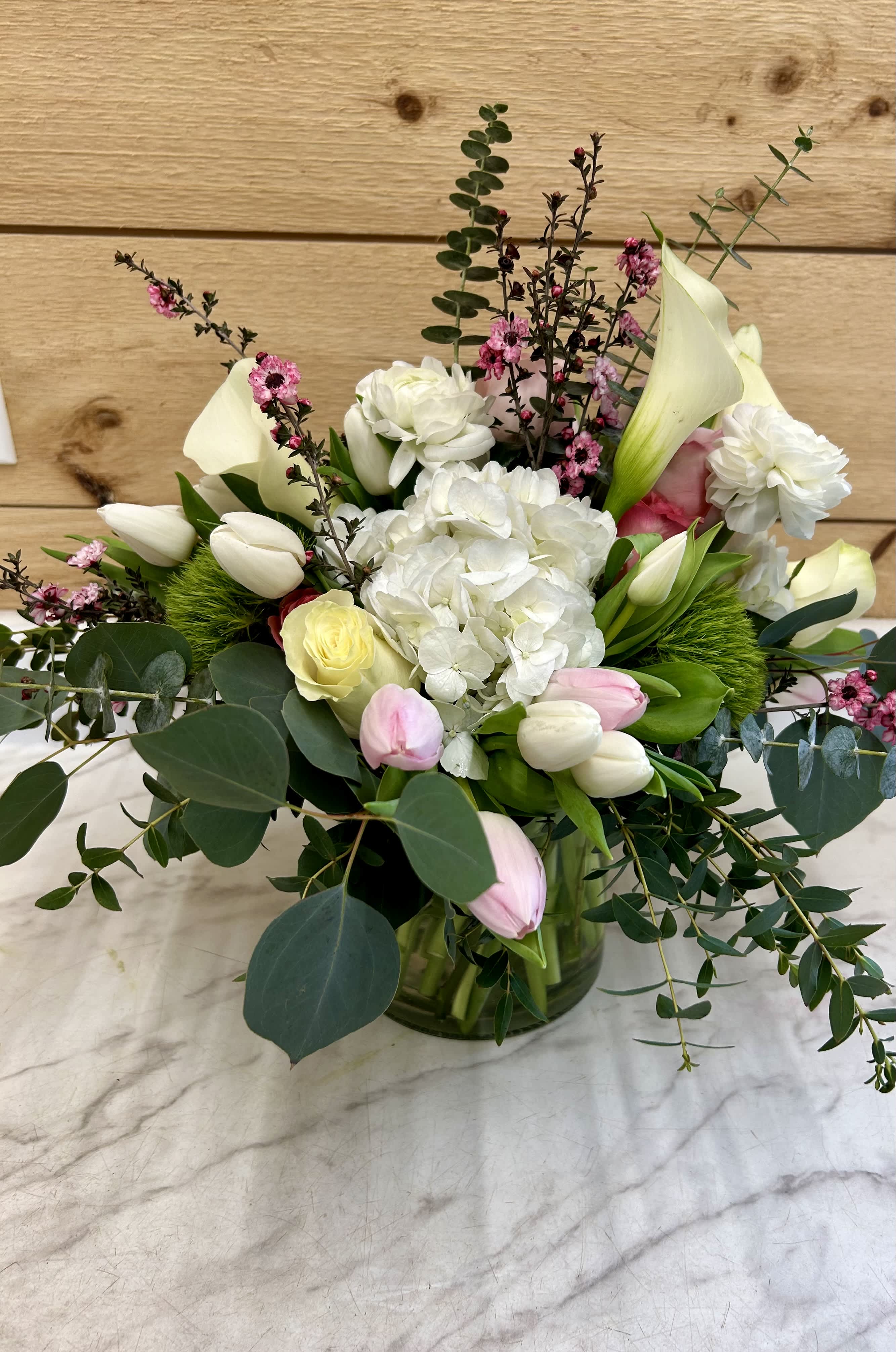 Bouquet of white and pink flowers in a glass vase