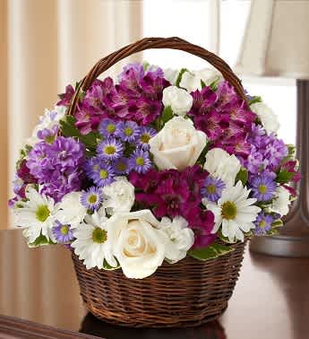 Peace, Prayers, &amp; Blessings- Lavender and White - Product ID: 95425   Express your heartfelt sympathy with a graceful arrangement of peaceful lavender and white blooms such as roses, stock, alstroemeria and more. Designed by hand in a lovely basket, it's a beautiful tribute to a life well lived. Graceful lavender and white arrangement of roses, stock, alstroemeria, daisy poms, mini carnations and monte casino, accented with variegated pittosporum and myrtle Hand-arranged in a willow handled basket; measures 8"H Appropriate to send to the home of friends and family members or to the memorial service Large arrangement measures approximately 12"H x 12"L Medium arrangement measures approximately 11"H x 11"L Small arrangement measures approximately 10"H X 10"L Our florists hand-design each arrangement, so colors, varieties, and basket may vary due to local availability days