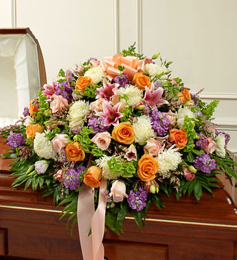 Cherished Memories Pastel Half Casket Cover - Product ID: 91402   Their life was filled with beauty and joy. Remember all the love and happiness they shared with this casket cover arrangement in soothing and delicate pastel shades. Our expert florists use their artistic skills to create a touching final tribute for an immediate family member who meant more than words can ever convey. Half casket cover arrangement of fresh pastel blooms such as long-stem roses, lilies, mums, Bells of Ireland, stock, lisianthus, heather and more Traditionally sent by the immediate family to the funeral home Our florists use only the freshest flowers available, so colors and varieties may vary Measures approximately 18âH x 38"L x 28"D