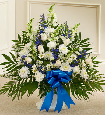 Tribute Blue &amp; White Floor Basket Arrangement - Product ID: 91208   Our elegant floor basket arrangement is a heartfelt way to express your deepest sympathies for their loss. With blue flowers to symbolize tranquility and white flowers to symbolize peace, this beautiful gathering of fresh roses, snapdragons, blue delphinium and more conveys all the care and concern you feel for them during this difficult time. Floor basket arrangement of fresh white roses, snapdragons, carnations, blue delphinium and more Appropriate for family, friends or business associates to send directly to the funeral home Our florists use only the freshest flowers available, so colors and varieties may vary Large arrangement measures approximately 32"H x 42"L Medium arrangement measures approximately 32"H x 40"L Small arrangement measures approximately 32"H x 36"L