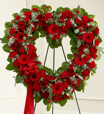 Always Remember Red Floral Heart Tribute - Product ID: 91246   The passing of someone we love deeply requires a special tribute. This open heart standing arrangement of fresh red blooms is designed by our expert florists to help your express all the devotion and sympathy you want to convey at a sad and difficult time. Heart-shaped arrangement of fresh red roses, gerbera daisies, carnations and more Accented by babyâs breath, salal, seeded eucalyptus and more Comes on a wire easel with accents and satin ribbon Appropriate for family and friends to send directly to the funeral home Our florists use only the freshest flowers available, so colors and assortment may vary Measures approximately 26"H x 28"W without easel