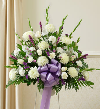 Heartfelt Sympathies Lavender Standing Basket - Product ID: 91269   In the language of flowers, lavender symbolizes love and devotion. Whether you are sending this to a beloved family member, friend, or someone you work with, this standing basket is a beautiful choice. Crafted by our expert florists from the freshest and loveliest lavender blooms, it helps you convey the sympathy you feel at this sorrowful time. Standing basket arrangement of fresh lavender and white flowers such as roses, football mums, gladiolus, liatris, Monte Casino and more Appropriate for family, friends or business associates to send directly to the funeral home Our florists use only the freshest flowers available, so colors and varieties may vary Large measures approximately 38"H x 40"L without stand Medium measures approximately 36"H x 38"L without stand Small measures approximately 32"H x 36"L without stand Stand may not be available in all areas
