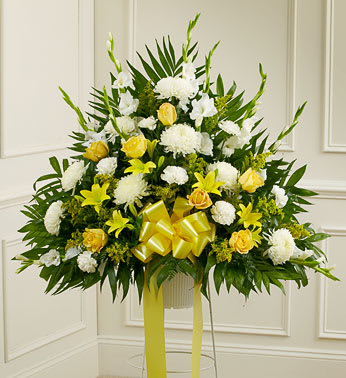 Heartfelt Sympathies Yellow Standing Basket - Product ID: 91263   It is customary to honor a life well lived with a final tribute that not only commemorates that life, but offers a message of hope and love to the family and friends left behind. This standing sympathy basket, crafted by our expert florists, is filled with yellow and white blooms, creating a touching and heartfelt memorial. Standing basket arrangement of fresh yellow and white flowers such as roses, lilies, mums, carnations and more Appropriate for family, friends or business associates to send directly to the funeral home Our florists use only the freshest flowers available, so colors and varieties may vary Large measures approximately 38"H x 38"L without stand Medium measures approximately 32"H x 36"L without stand Small measures approximately 30"H x 34"L without stand Stand may not be available in all areas