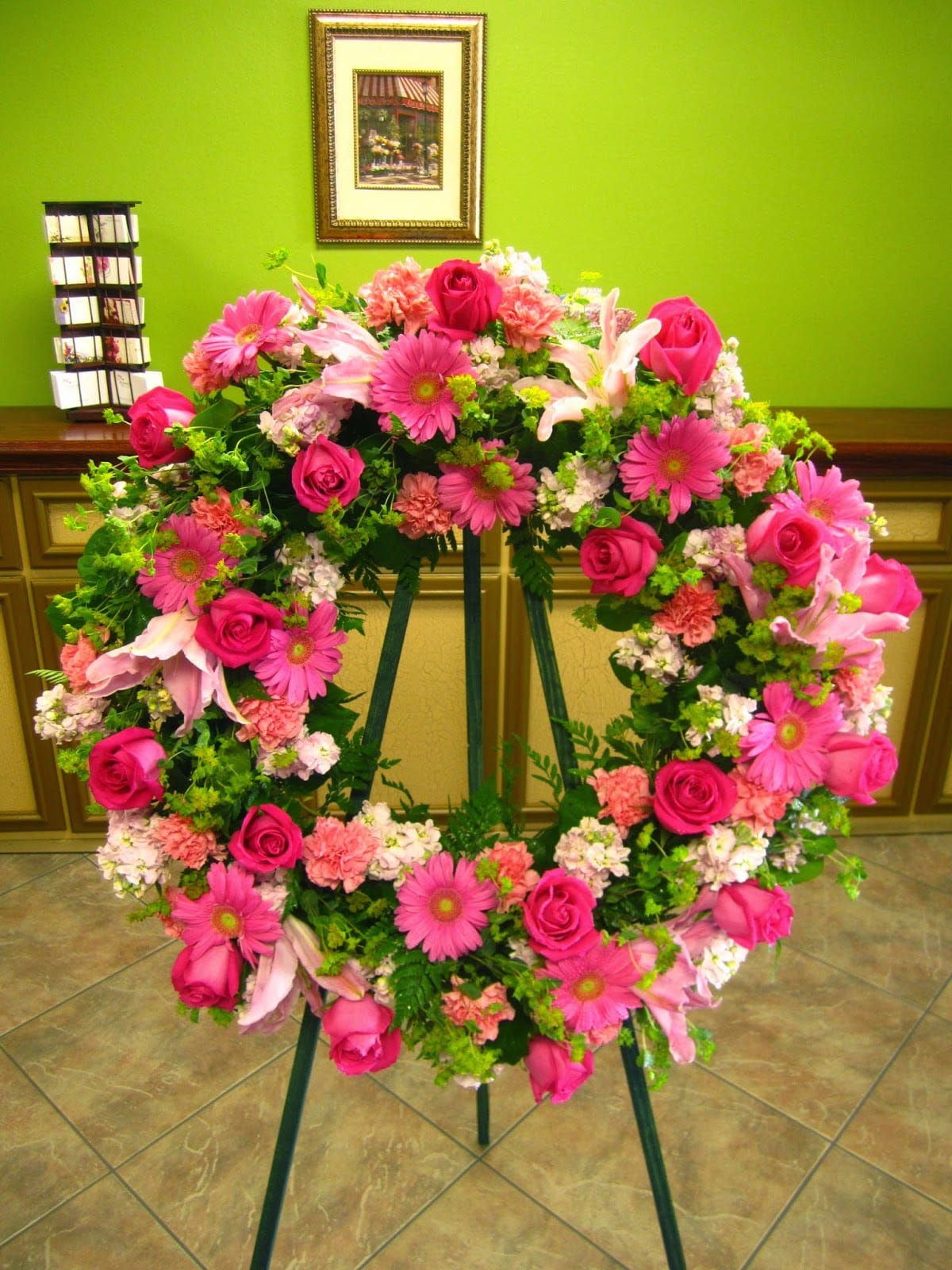 BFS-W14 Wreath - A sympathy wreath of gentle beauty, this arrangement is an exquisite blend of pink and white flowers, meticulously composed to create a serene and comforting tribute. Measuring a substantial 26 inches in width, the wreath offers a thoughtful expression of condolences during a time of loss.